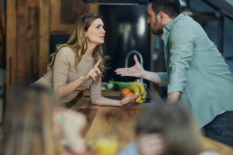 Frustrated parents having an argument in the kitchen | Peek Goldstone