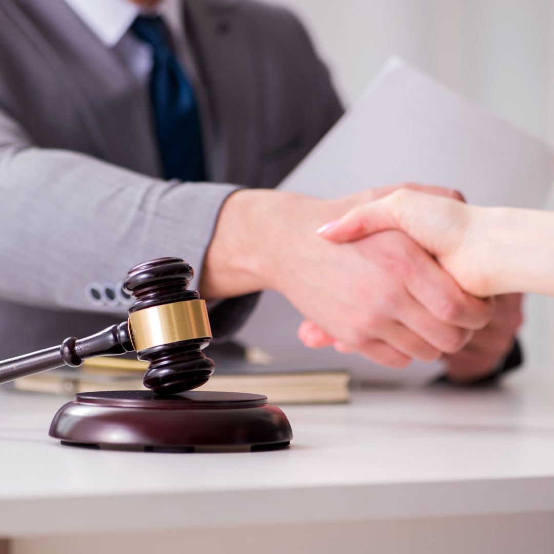 lawyer shaking hands with teenager